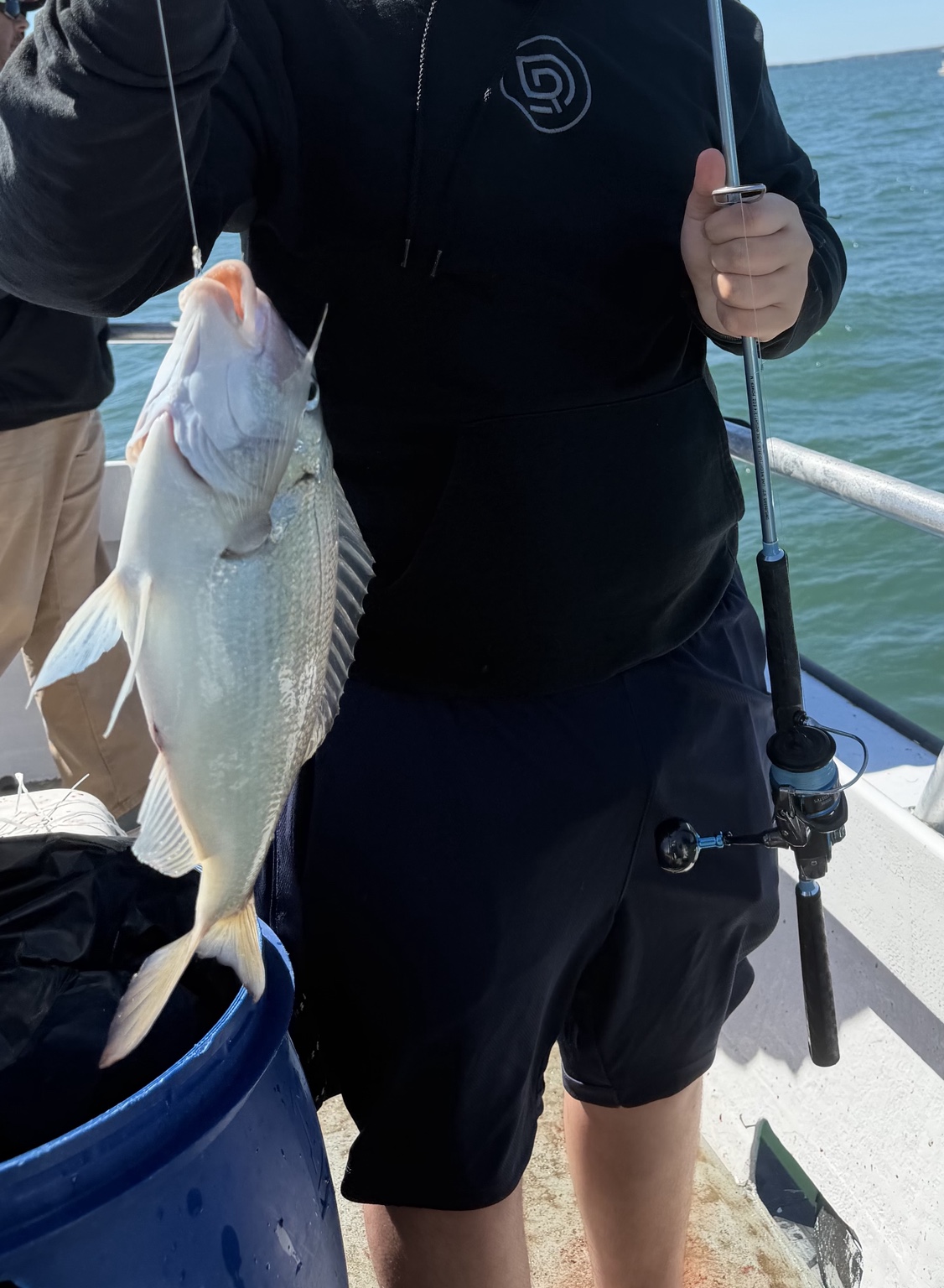 Young angler holding a fish on a party boat