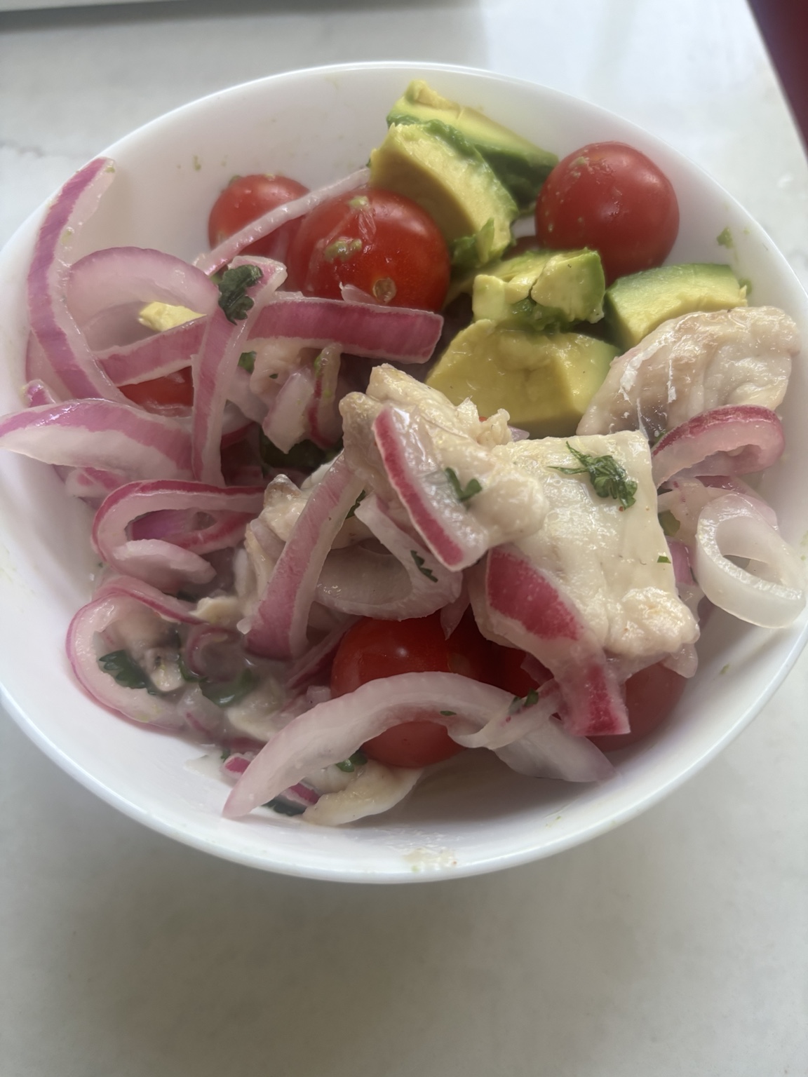 Fresh porgy ceviche with avocado, tomato, red onion, and citrus